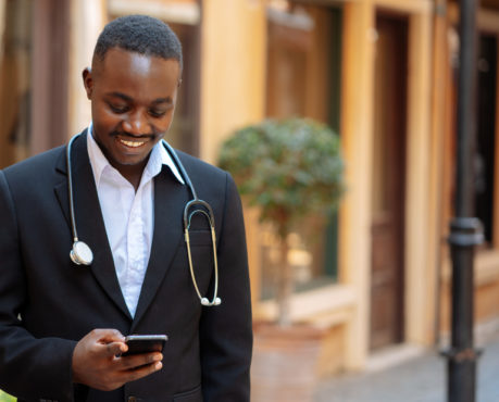 African doctor with phone