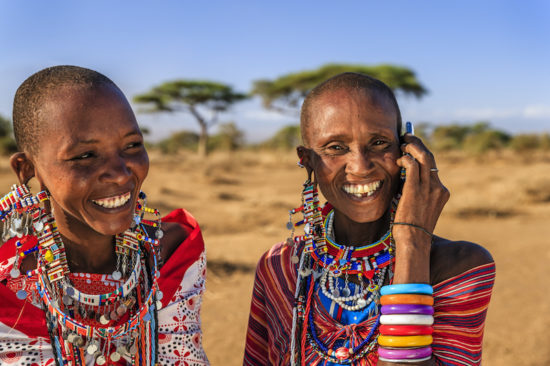 African woman from Maasai tribe using mobile phone